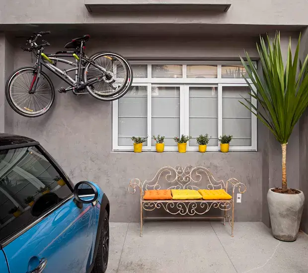 13. Yellow gray outdoor bench and garage with car